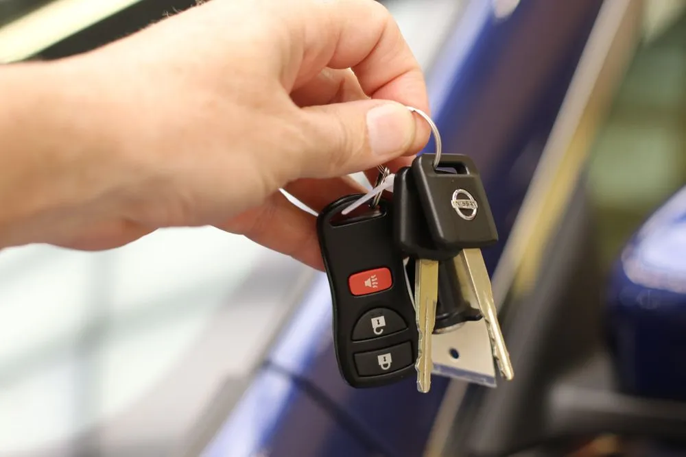 Car key being used to unlock a vehicle during roadside assistance